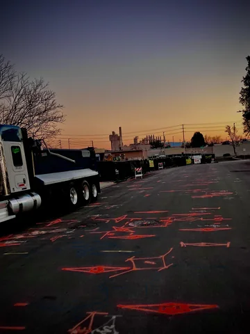 Work truck staged on a street covered in fresh utility locate markings