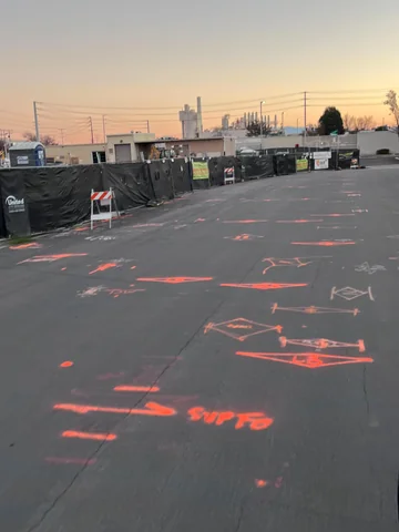 Underground utility vault and marked pavement on a commercial site